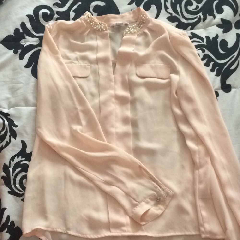 Light pink/creme colored blouse.